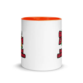 a white and orange coffee mug with a red rim
