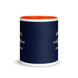 a blue and orange coffee mug with a white bottom
