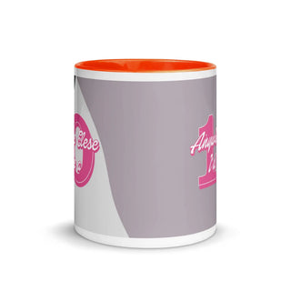 an orange and white coffee mug with a pink handle