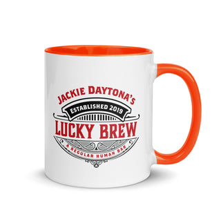 a white and orange coffee mug with the words lucky brew on it
