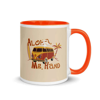 an orange and white coffee mug with an orange handle