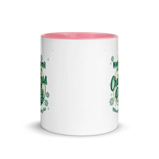 a white and pink coffee mug with shamrocks on it